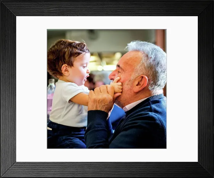 Framed Print : Senior man face to face with baby grandson in cafe Framed Print : Senior man face to face with baby grandson in cafe