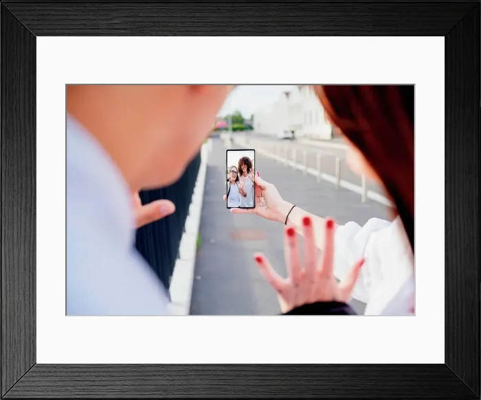 Framed Print : Mixed race group of friends chatting via mobile phone