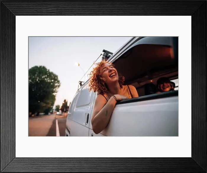 Framed Print : Happy young woman leaning out of van window Framed Print : Happy young woman leaning out of van window
