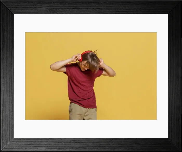 Framed Print : Carefree young man with headphones listening to music Framed Print : Carefree young man with headphones listening to music