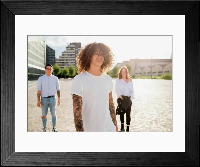 Framed Print : Mixed race group of friends hanging out together in town