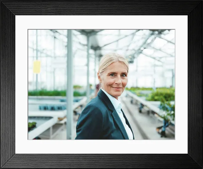 Framed Print : Smiling agronomist in garden center Framed Print : Smiling agronomist in garden center