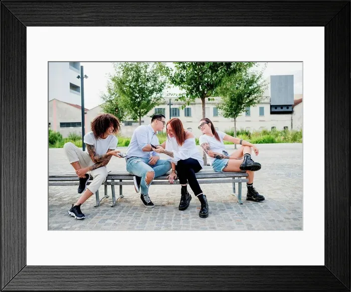 Framed Print : Mixed race group of friends hanging out together in town