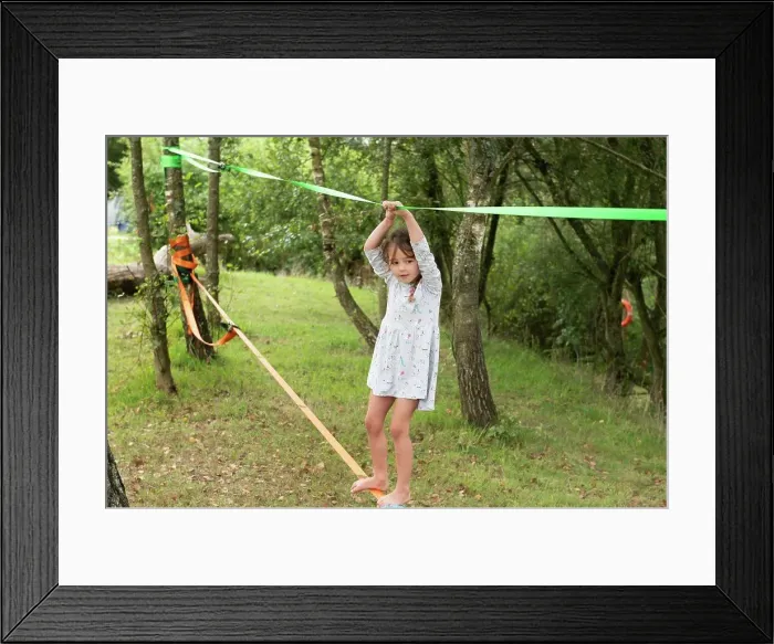 Framed Print : UK, Girl on slackline in park Framed Print : UK, Girl on slackline in park