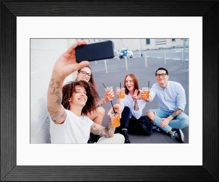 Framed Print : Mixed race group of friends hanging out together in town, taking selfie with mobile phone Framed Print : Mixed race group of friends hanging out together in town, taking selfie with mobile phone