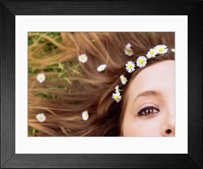 Framed Print : Woman lying on a meadow wearing daisies in her hair, close-up Framed Print : Woman lying on a meadow wearing daisies in her hair, close-up