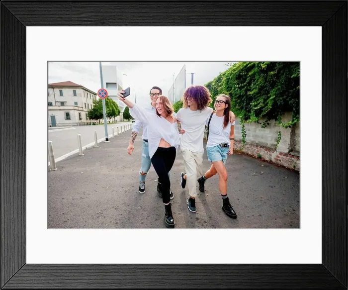 Framed Print : Mixed race group of friends hanging out together in town, taking selfie with mobile phone Framed Print : Mixed race group of friends hanging out together in town, taking selfie with mobile phone