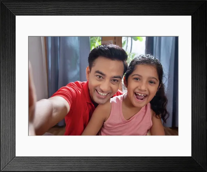 Framed Print : Father and daughter enjoying at home Taking selfies with smart phone
