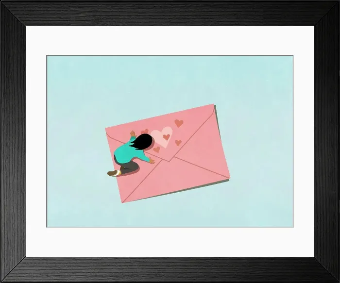 Framed Print : Woman kneeling over pink envelope with hearts