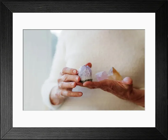 Framed Print : Hands of senior woman holding crystal stones Framed Print : Hands of senior woman holding crystal stones