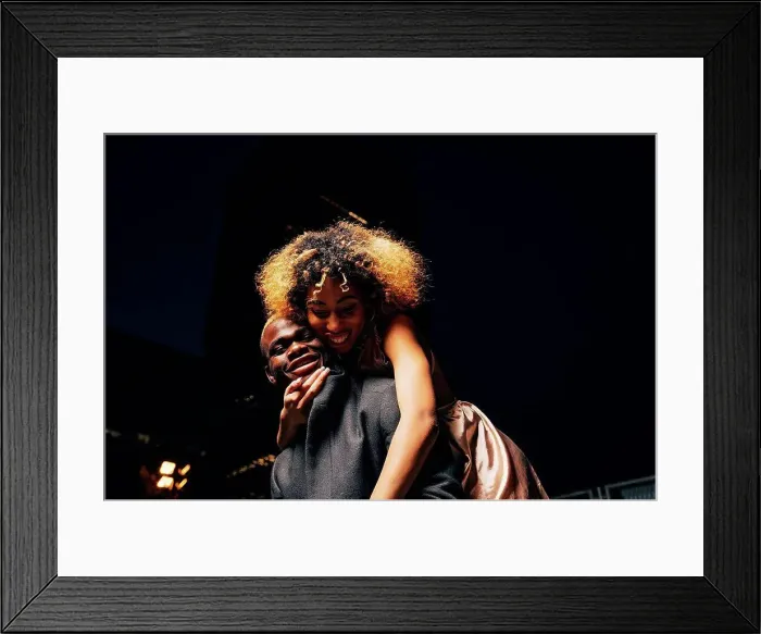 Framed Print : Young couple having fun together at night outdoors Framed Print : Young couple having fun together at night outdoors