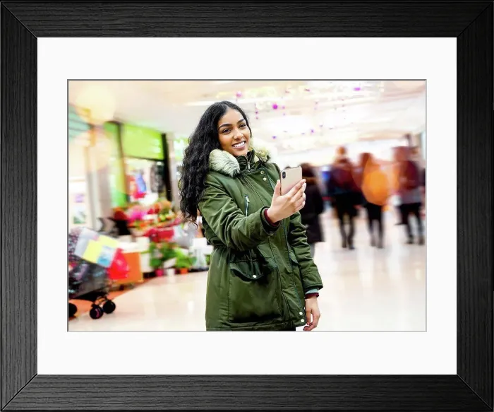 Framed Print : Young woman taking selfie in shopping mall Framed Print : Young woman taking selfie in shopping mall