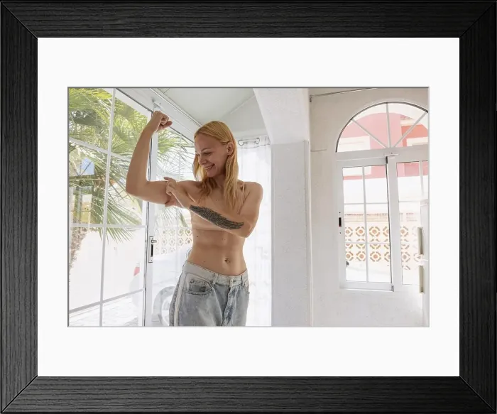 Framed Print : The concept of a successful diet. Cropped shot of a young woman in oversized jeans showing the resul
