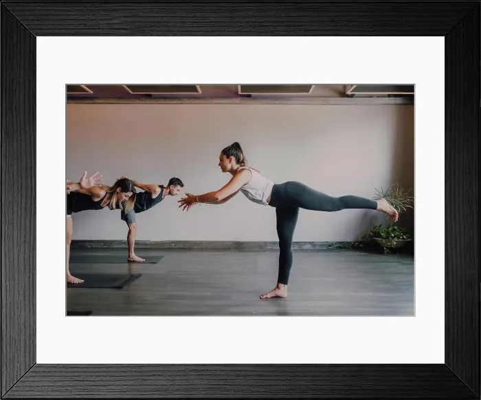 Framed Print : Slim barefoot female instructor in sportswear standing in warrior pose three Framed Print : Slim barefoot female instructor in sportswear standing in warrior pose three