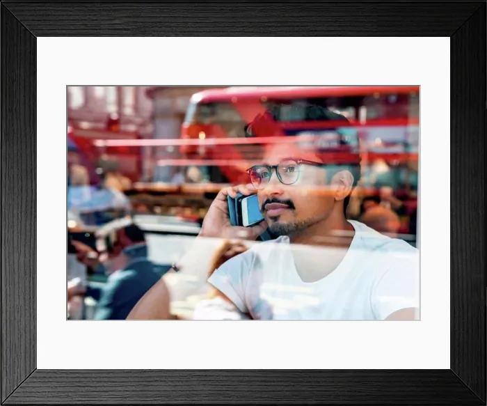 Framed Print : Man using smartphone in cafe Framed Print : Man using smartphone in cafe