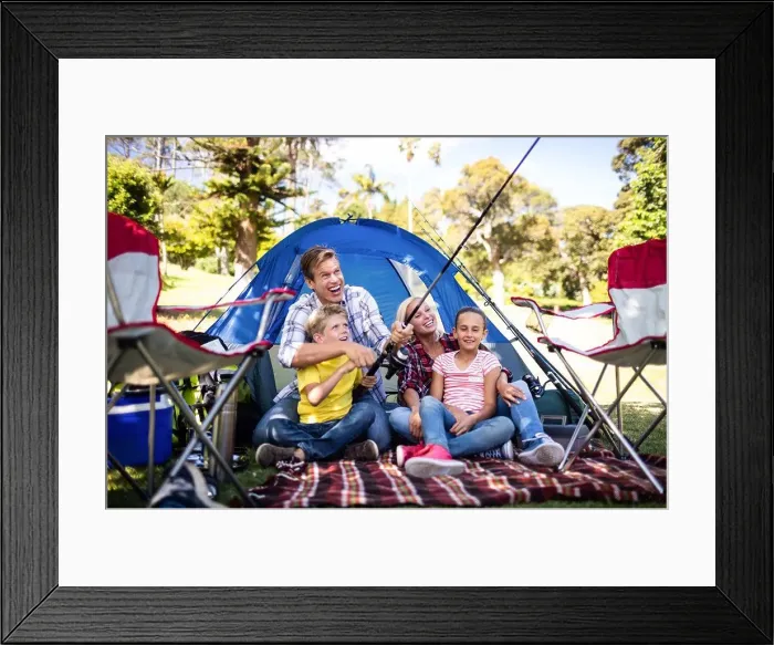 Framed Print : Family on a camping trip fishing outside their tent Framed Print : Family on a camping trip fishing outside their tent