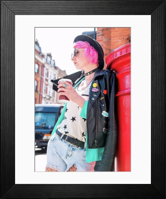 Framed Print : Young woman with pink hair and quirky style leaning against red mailbox, London, UK