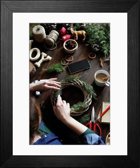 Framed Print : Woman decorating Advent wreath on work table, partial view Framed Print : Woman decorating Advent wreath on work table, partial view