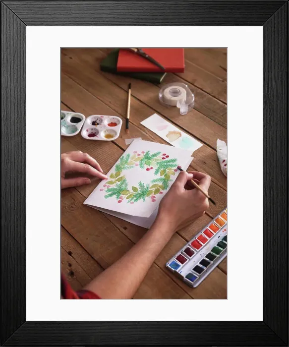 Framed Print : Young woman painting Christmas card with water colors, close-up Framed Print : Young woman painting Christmas card with water colors, close-up