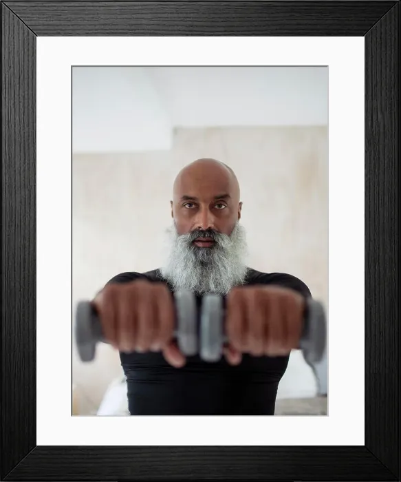 Framed Print : Focused senior man exercising with dumbbells Framed Print : Focused senior man exercising with dumbbells