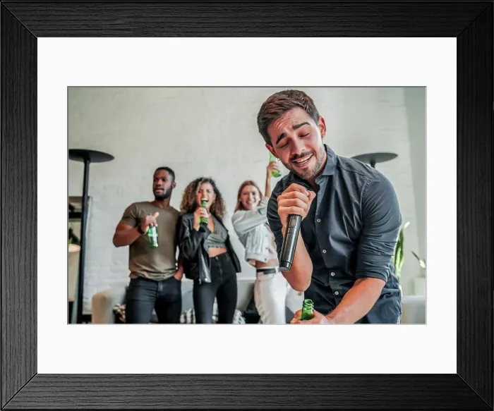 Framed Print : Group of friends having fun together while playing with a karaoke at home. Friends concept Framed Print : Group of friends having fun together while playing with a karaoke at home. Friends concept