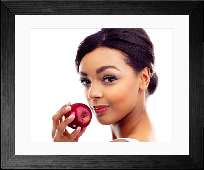 Framed Print : The perfect diet snack. A young woman holding an apple and smiling at the camera Framed Print : The perfect diet snack. A young woman holding an apple and smiling at the camera