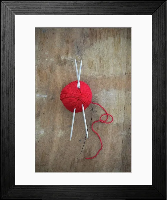 Framed Print : Red ball of wool and knitting needles on wood
