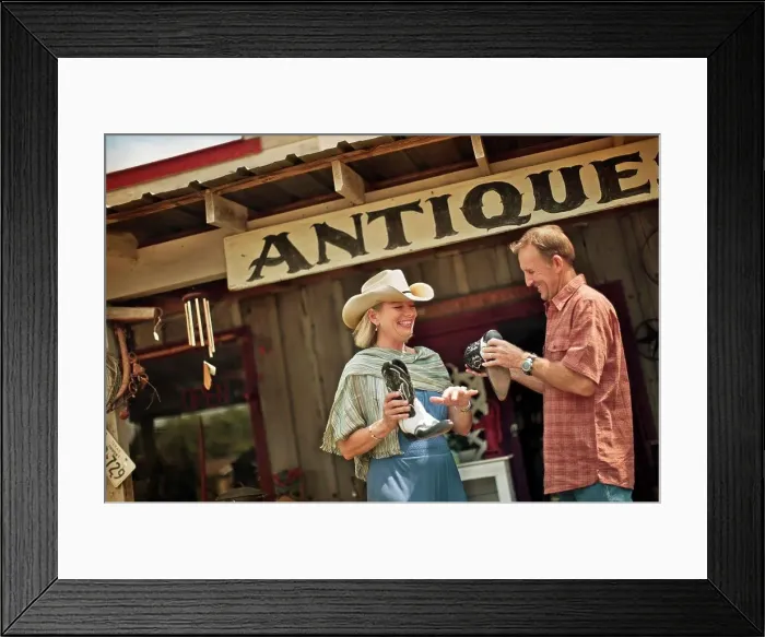 Framed Print : Smiling mature couple have fun shopping at the antique store together Framed Print : Smiling mature couple have fun shopping at the antique store together
