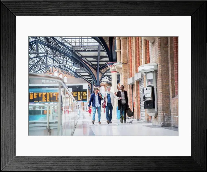 Framed Print : Three mature men at train station, walking together Framed Print : Three mature men at train station, walking together
