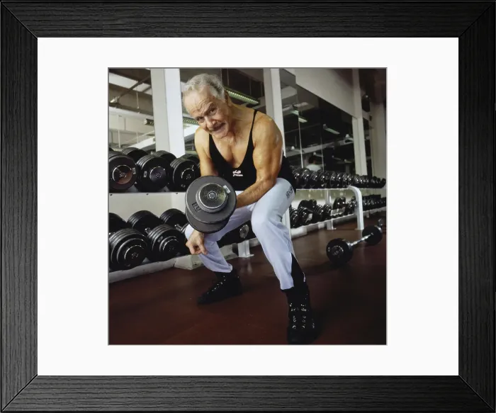 Framed Print : Portrait of a mature man exercising with dumbbells Framed Print : Portrait of a mature man exercising with dumbbells