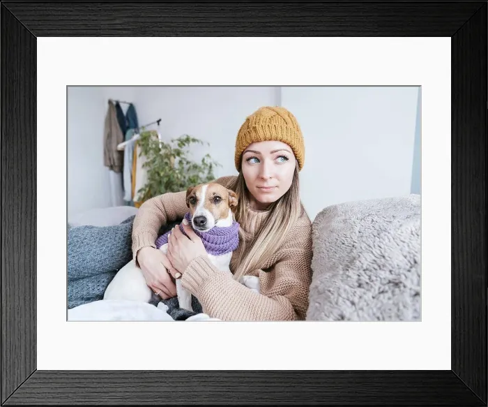 Framed Print : Woman wearing warm clothing cuddling with dog in bed Framed Print : Woman wearing warm clothing cuddling with dog in bed
