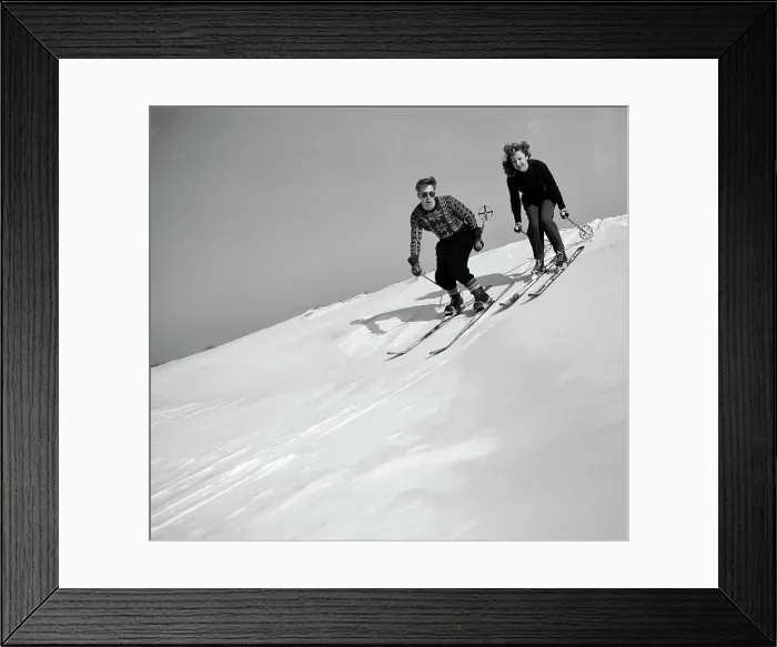 Framed Print : Young couple skiing down the slope Framed Print : Young couple skiing down the slope