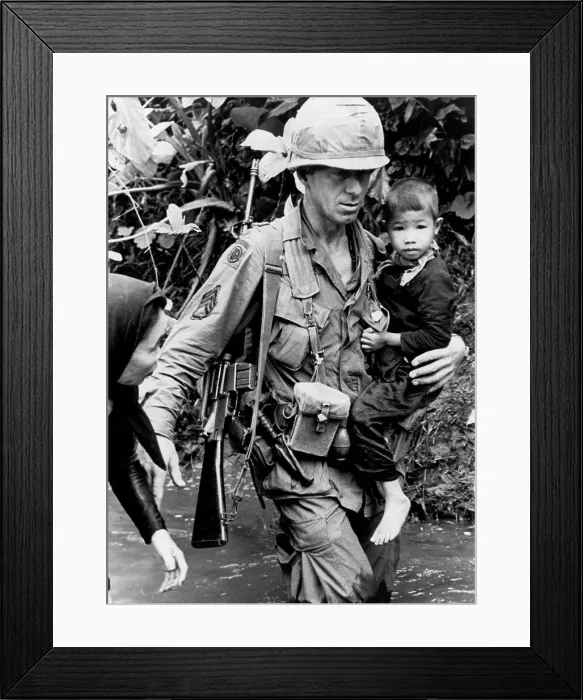 Framed Print : An Khe, Vietnam: 1967 A member of the 1st Calvary Division helps a Vietnamese woman and her child across a stream Framed Print : An Khe, Vietnam: 1967 A member of the 1st Calvary Division helps a Vietnamese woman and her child across a stream