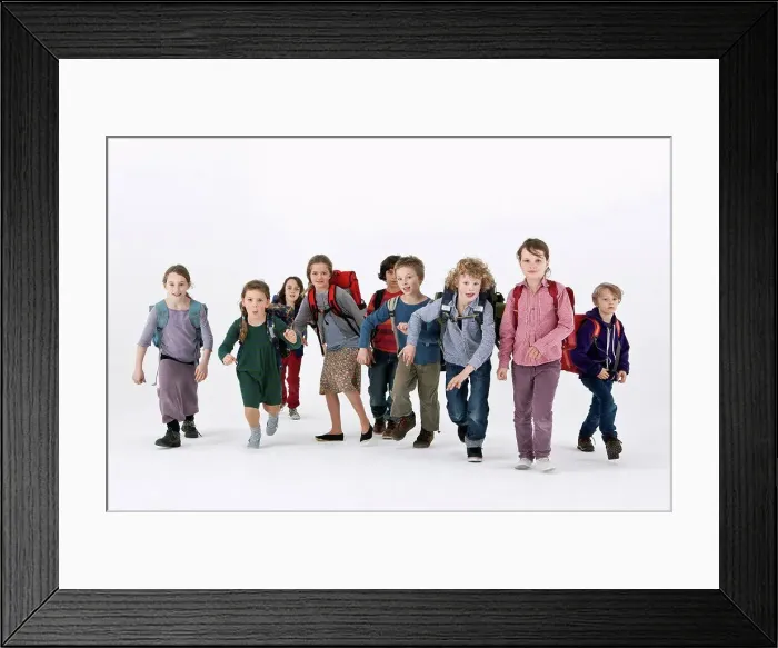 Framed Print : A group of school kids wearing backpacks and running forward Framed Print : A group of school kids wearing backpacks and running forward