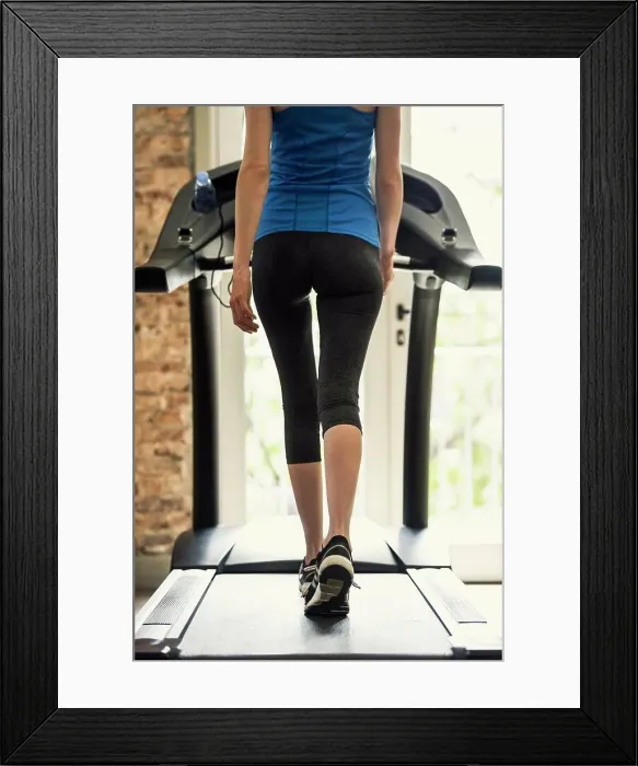 Framed Print : Woman exercising on treadmill