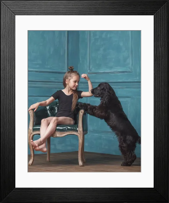 Framed Print : Full length of girl sitting on antique chair while looking at dog rearing up at home Framed Print : Full length of girl sitting on antique chair while looking at dog rearing up at home