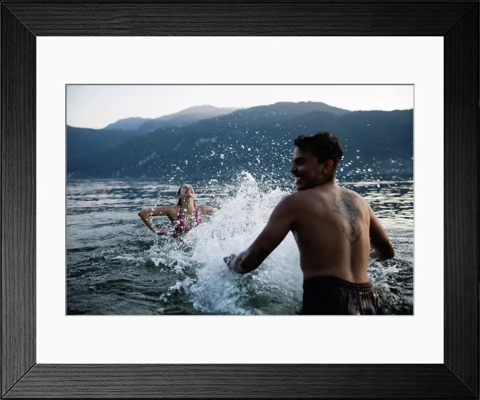 Framed Print : Happy young couple playing in a lake Framed Print : Happy young couple playing in a lake