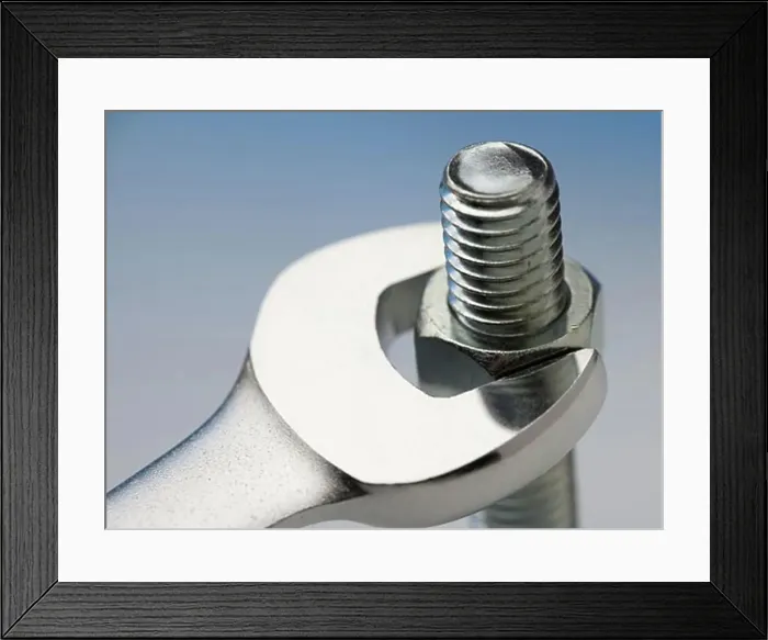 Framed Print : Wrench turning nut on bolt Framed Print : Wrench turning nut on bolt