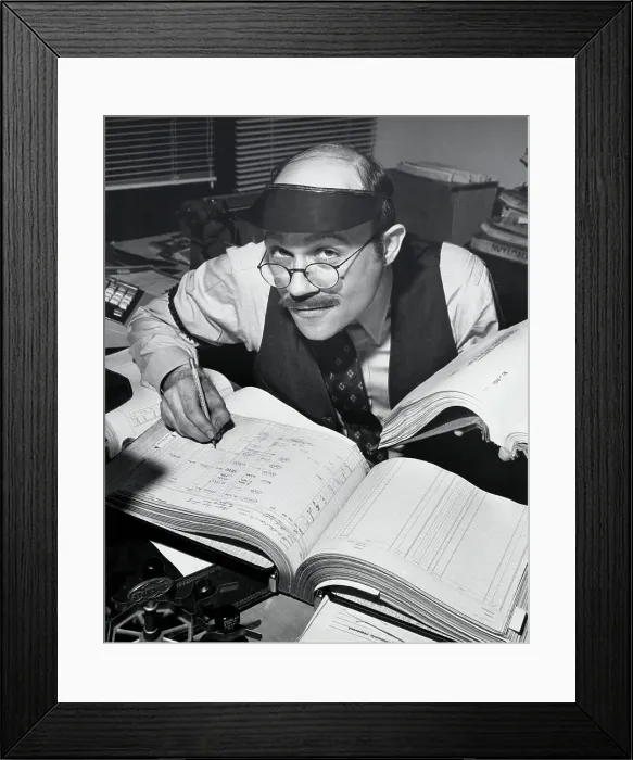 Framed Print : Portrait of a businessman working on accounting ledgers Framed Print : Portrait of a businessman working on accounting ledgers
