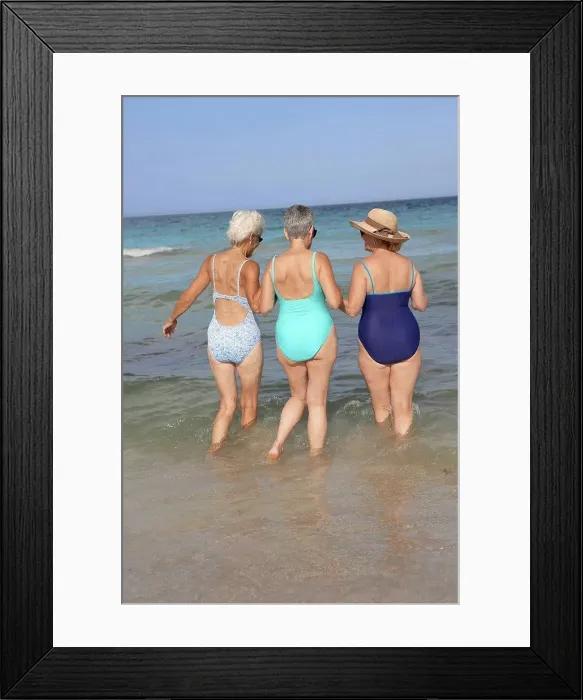 Framed Print : Senior women walking in waves on beach Framed Print : Senior women walking in waves on beach