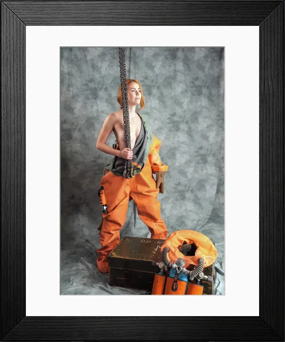 Framed Print : Nude young woman with red hair and freckles with a chain in her hands in a vintage diving suit Framed Print : Nude young woman with red hair and freckles with a chain in her hands in a vintage diving suit