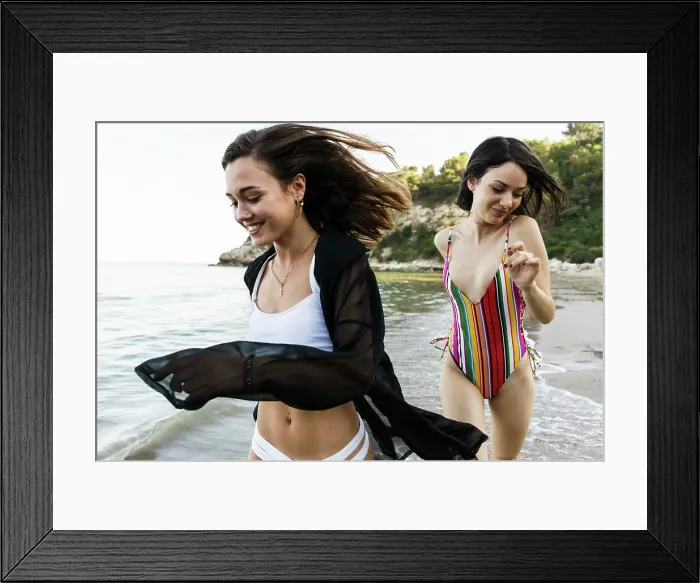 Framed Print : Cheerful girls running on beach