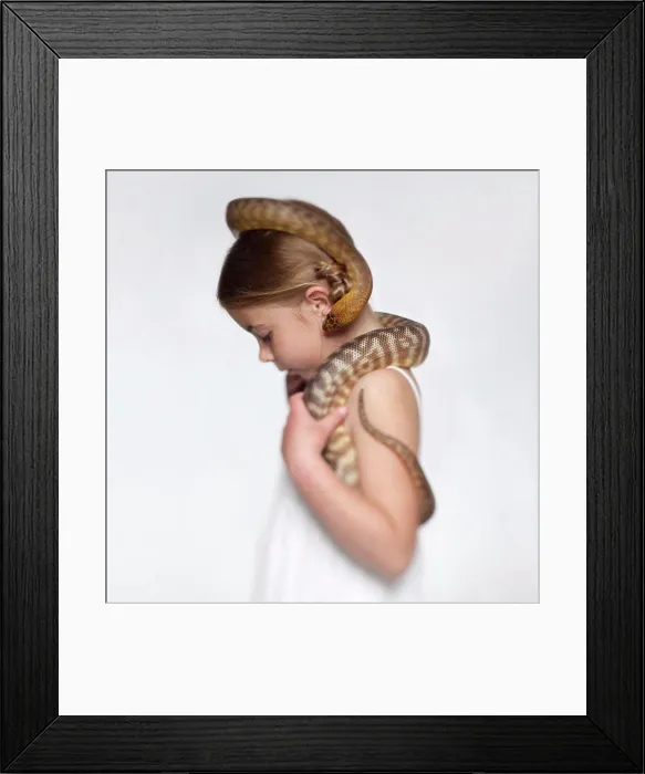 Framed Print : Studio portrait of girl (6-7) with snake Framed Print : Studio portrait of girl (6-7) with snake