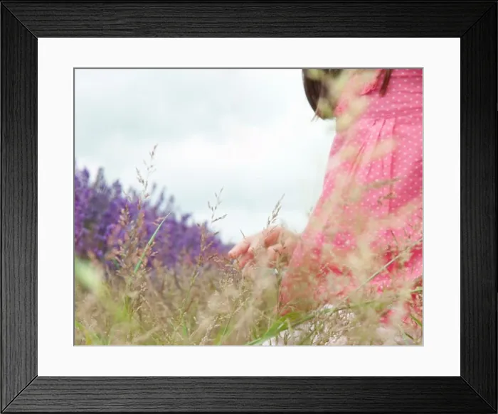 Framed Print : Close up of girl in field of flowers