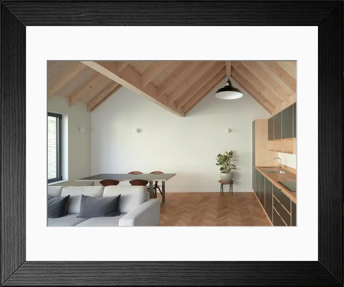 Framed Print : A view of the open plan living room / kitchen with vaulted ceiling and soft furnishings