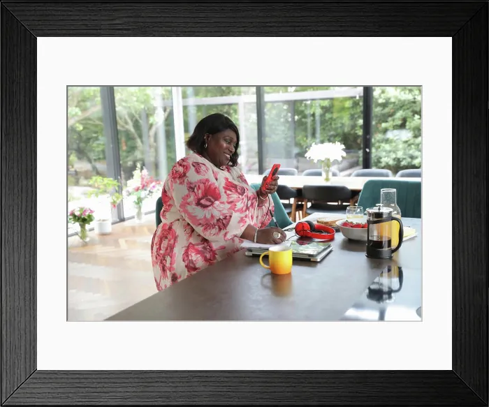 Framed Print : Woman using smart phone at home