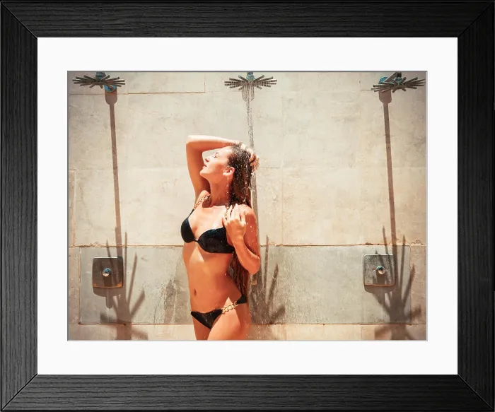 Framed Print : Woman in tropical garden having shower outdoors. Close up