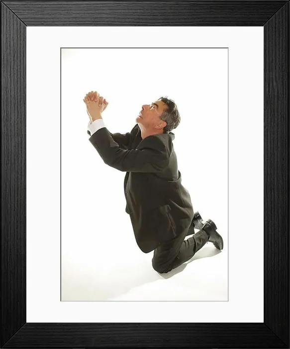 Framed Print : Kneeling businessman praying for mercy Framed Print : Kneeling businessman praying for mercy