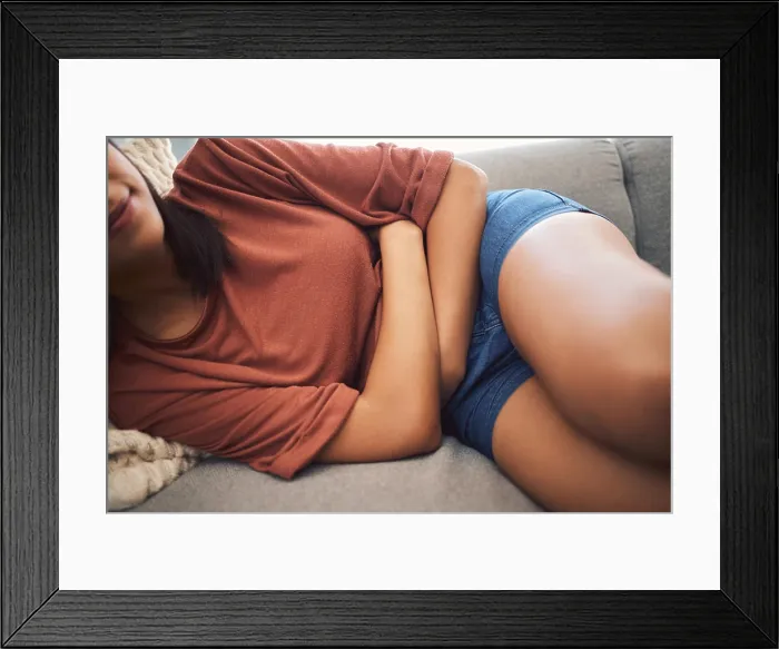 Framed Print : Woman, period and stomach pain in home Framed Print : Woman, period and stomach pain in home