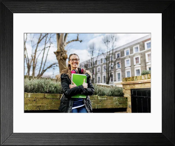 Framed Print : London, student girl with headphone and writing pad, language holiday